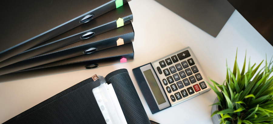Calculator and bi8nders on desk