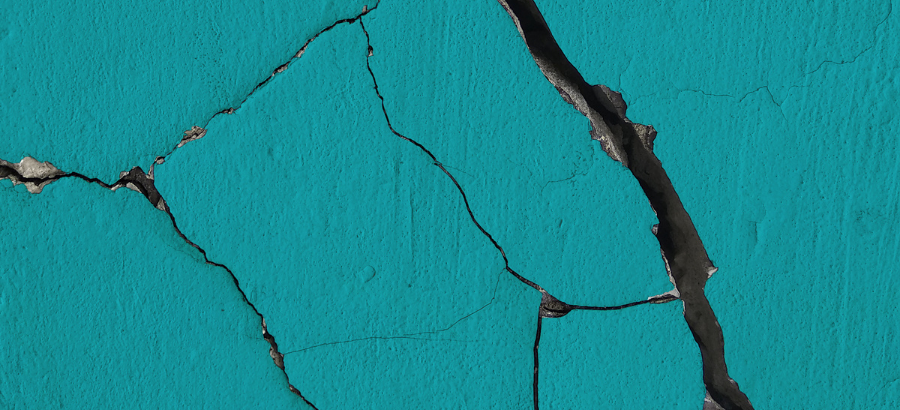 Teal coloured cracked wall