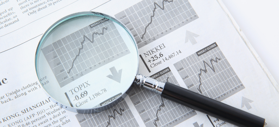 Magnifying glass with a teal tint on report with a graph