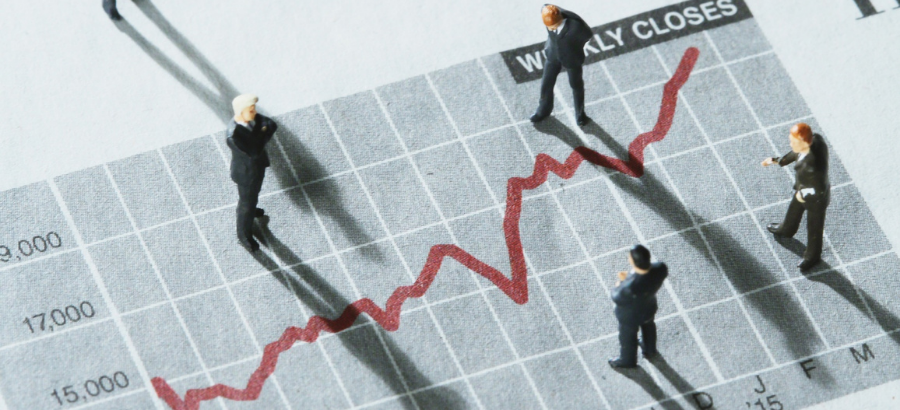 Small human figurines standing on red-lined graph