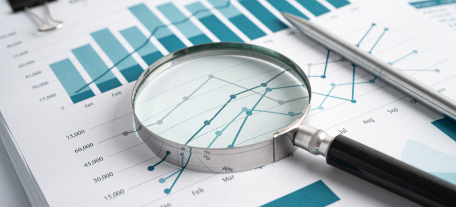 Magnifying glass on teal toned graphs